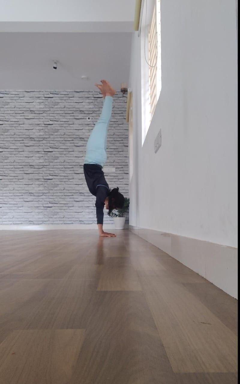 Handstand on wooden floor studio